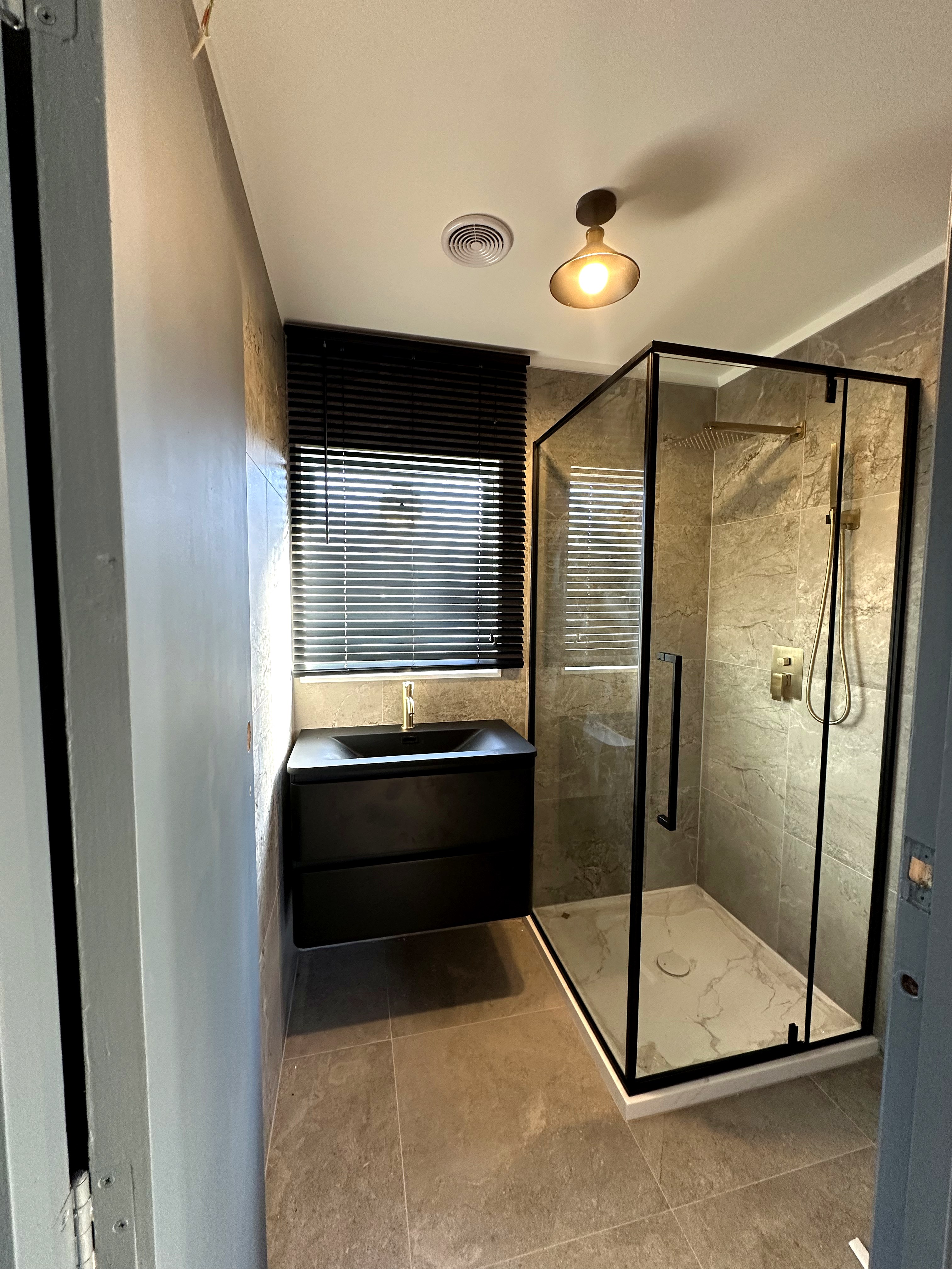 New tiled bathroom gold fixtures